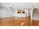 Open-concept living space with hard wood floors and view of the kitchen and staircase at 10817 Great Carlisle Ct, Riverview, FL 33578