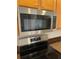 Stainless steel GE microwave mounted over the stove with a sleek design at 10817 Great Carlisle Ct, Riverview, FL 33578