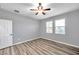 Well-lit bedroom with ceiling fan and wood-look flooring at 10824 79Th E St, Parrish, FL 34219