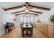 Bright dining room with exposed beam ceiling, natural light, and built-in cabinets at 1131 Snell Isle Ne Blvd, St Petersburg, FL 33704