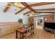 Charming dining room with exposed beam ceiling, brick accent wall, and custom built-in cabinets at 1131 Snell Isle Ne Blvd, St Petersburg, FL 33704