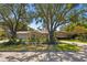 Charming ranch house with a long driveway, beautiful landscaping, and large shade trees at 1131 Snell Isle Ne Blvd, St Petersburg, FL 33704