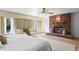 Bright main bedroom with a brick fireplace, elegant seating area, and soft natural light at 1131 Snell Isle Ne Blvd, St Petersburg, FL 33704