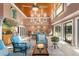 Bright sunroom with multiple seating areas and pool access at 1131 Snell Isle Ne Blvd, St Petersburg, FL 33704