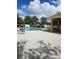 Community pool with lounge chairs and covered seating area at 1252 Costa Mesa Dr, Wesley Chapel, FL 33543