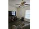 Living room with gray couch, TV, and dark gray floors at 1252 Costa Mesa Dr, Wesley Chapel, FL 33543