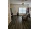 Living room with gray chair, dark gray floors, and ceiling fan at 1252 Costa Mesa Dr, Wesley Chapel, FL 33543