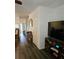 Living room with dark gray floors and a view to the dining area at 1252 Costa Mesa Dr, Wesley Chapel, FL 33543