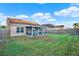 Spacious backyard with screened patio and wooden fence at 12612 Midpointe Dr, Riverview, FL 33579