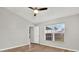 Bright bedroom with wood-look floors and ceiling fan at 12612 Midpointe Dr, Riverview, FL 33579