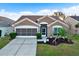 Attractive single-story home with a two-car garage and landscaped front yard at 12612 Midpointe Dr, Riverview, FL 33579