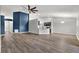 Open-concept living room with kitchen island and modern finishes at 12612 Midpointe Dr, Riverview, FL 33579
