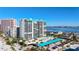 Aerial view of condo building near the waterfront with parking at 1390 Gulf Blvd # 302, Clearwater Beach, FL 33767