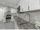 Renovated kitchen featuring white shaker cabinets and hexagon tile backsplash at 1428 Illinois Ave, Palm Harbor, FL 34683