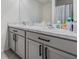 Double vanity bathroom with grey cabinets and marble countertop at 16838 Delia St, Wimauma, FL 33598