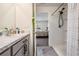 Bathroom with vanity, shower, and view into bedroom at 16838 Delia St, Wimauma, FL 33598