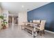 Dining room with modern table and bench, view into the kitchen at 16838 Delia St, Wimauma, FL 33598