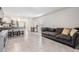 Living room with grey couch and view of kitchen at 16838 Delia St, Wimauma, FL 33598
