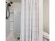Modern shower with a white tiled surround and built-in shelving at 16838 Delia St, Wimauma, FL 33598