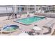 Inviting pool and hot tub area with lounge chairs and tables at 20002 Gulf Blvd # 2602, Indian Shores, FL 33785