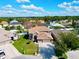 Aerial view of a two-story house with a large yard and two-car garage at 2012 Fern Ridge Ct, Holiday, FL 34691
