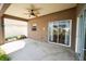 Covered patio with ceiling fan and sliding glass doors at 2012 Fern Ridge Ct, Holiday, FL 34691