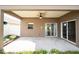 Covered patio with ceiling fan and sliding glass doors at 2012 Fern Ridge Ct, Holiday, FL 34691