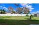 Large backyard with grassy area and white vinyl fence at 2012 Fern Ridge Ct, Holiday, FL 34691