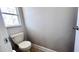 Simple half bathroom with a toilet and a window at 2012 Fern Ridge Ct, Holiday, FL 34691