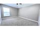 Bedroom with neutral walls, carpet flooring, and a window at 2012 Fern Ridge Ct, Holiday, FL 34691