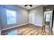 Cozy bedroom with hardwood floors and a window with blinds at 2012 Fern Ridge Ct, Holiday, FL 34691