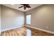 Well-lit bedroom with hardwood floors and ceiling fan at 2012 Fern Ridge Ct, Holiday, FL 34691