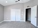 Spacious bedroom with double door closet and additional access to another room at 2012 Fern Ridge Ct, Holiday, FL 34691