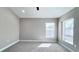 Well-lit bedroom with carpet floors and two windows at 2012 Fern Ridge Ct, Holiday, FL 34691