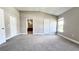 Bright bedroom featuring carpet floors and a view of the backyard at 2012 Fern Ridge Ct, Holiday, FL 34691