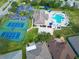 Aerial view of community pool, tennis courts, and clubhouse at 2012 Fern Ridge Ct, Holiday, FL 34691