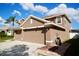 Two-story house with tan exterior, three-car garage, and manicured lawn at 2012 Fern Ridge Ct, Holiday, FL 34691