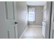 Laundry room with tile flooring, shelving and a utility sink at 2012 Fern Ridge Ct, Holiday, FL 34691