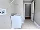 Laundry room with a utility sink and white cabinets at 2012 Fern Ridge Ct, Holiday, FL 34691