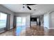 Living room showcasing hardwood floors, a ceiling fan, and views of the backyard at 2012 Fern Ridge Ct, Holiday, FL 34691