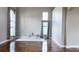 Living room with hardwood floors, large windows, and a cozy sitting area at 2012 Fern Ridge Ct, Holiday, FL 34691