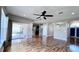 Open living room with hardwood floors, ceiling fan, and access to patio at 2012 Fern Ridge Ct, Holiday, FL 34691