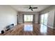 Spacious living room with hardwood floors, large windows, and a ceiling fan at 2012 Fern Ridge Ct, Holiday, FL 34691