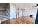 Living room with hardwood floors, staircase, and views into other rooms at 2012 Fern Ridge Ct, Holiday, FL 34691