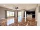 Living area with hardwood floors, ceiling fan, and sliding glass doors to patio at 2012 Fern Ridge Ct, Holiday, FL 34691