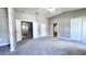 Spacious main bedroom with carpet and access to bathroom and closet at 2012 Fern Ridge Ct, Holiday, FL 34691