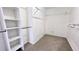 Large walk-in closet with shelves and hanging rods at 2012 Fern Ridge Ct, Holiday, FL 34691