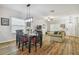 Bright dining area with wood floors, a table for six, and an open floor plan at 21149 Pleasant Plains Pkwy, Land O Lakes, FL 34637