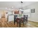 Bright dining area with modern light fixtures and a view of the kitchen at 21149 Pleasant Plains Pkwy, Land O Lakes, FL 34637