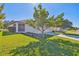 Beautiful home exterior featuring a manicured lawn, a mature shade tree, and a screened porch at 21149 Pleasant Plains Pkwy, Land O Lakes, FL 34637